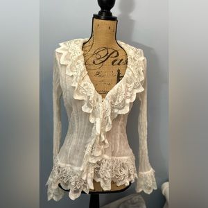 White, sheer, sexy lacy top long sleeves. Button down in the front.